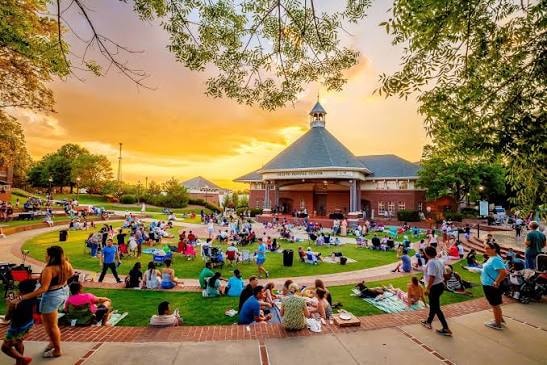 Downtown Duluth Town Green with live event crowd at sunset
