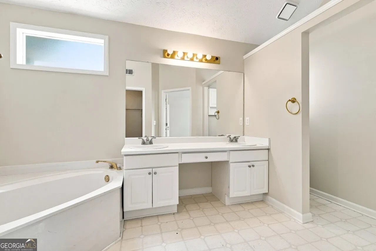 Primary bathroom with double vanity and soaking tub
