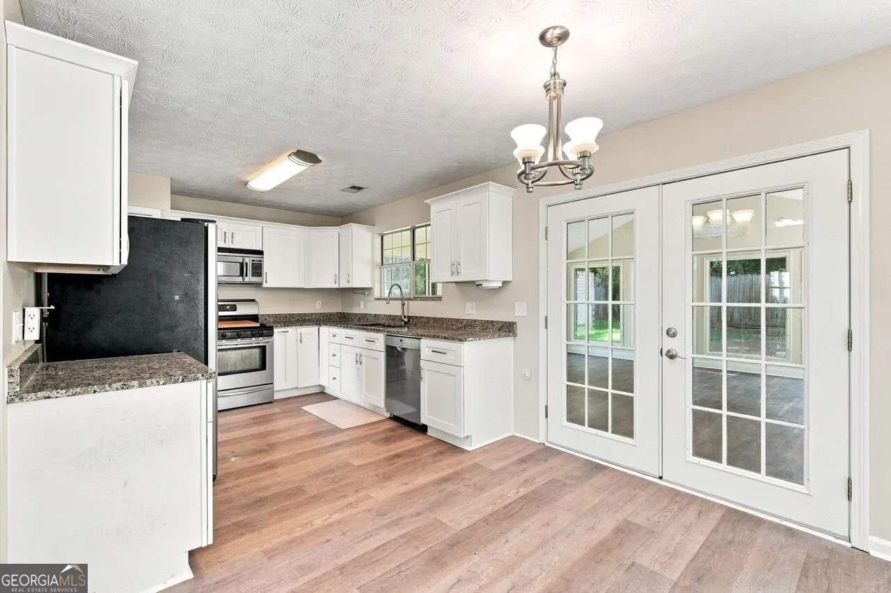 Kitchen with white cabinets and granite countertops