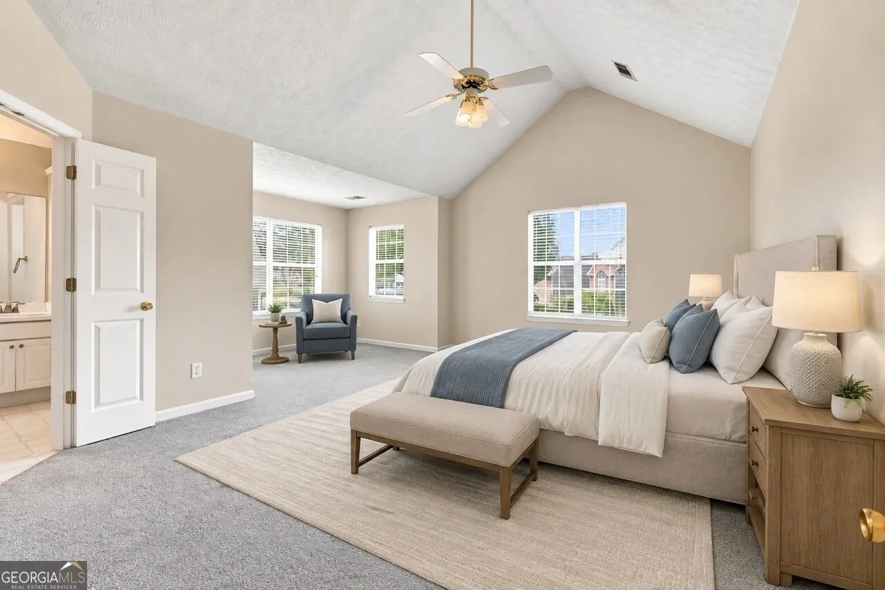 Primary bedroom with vaulted ceiling